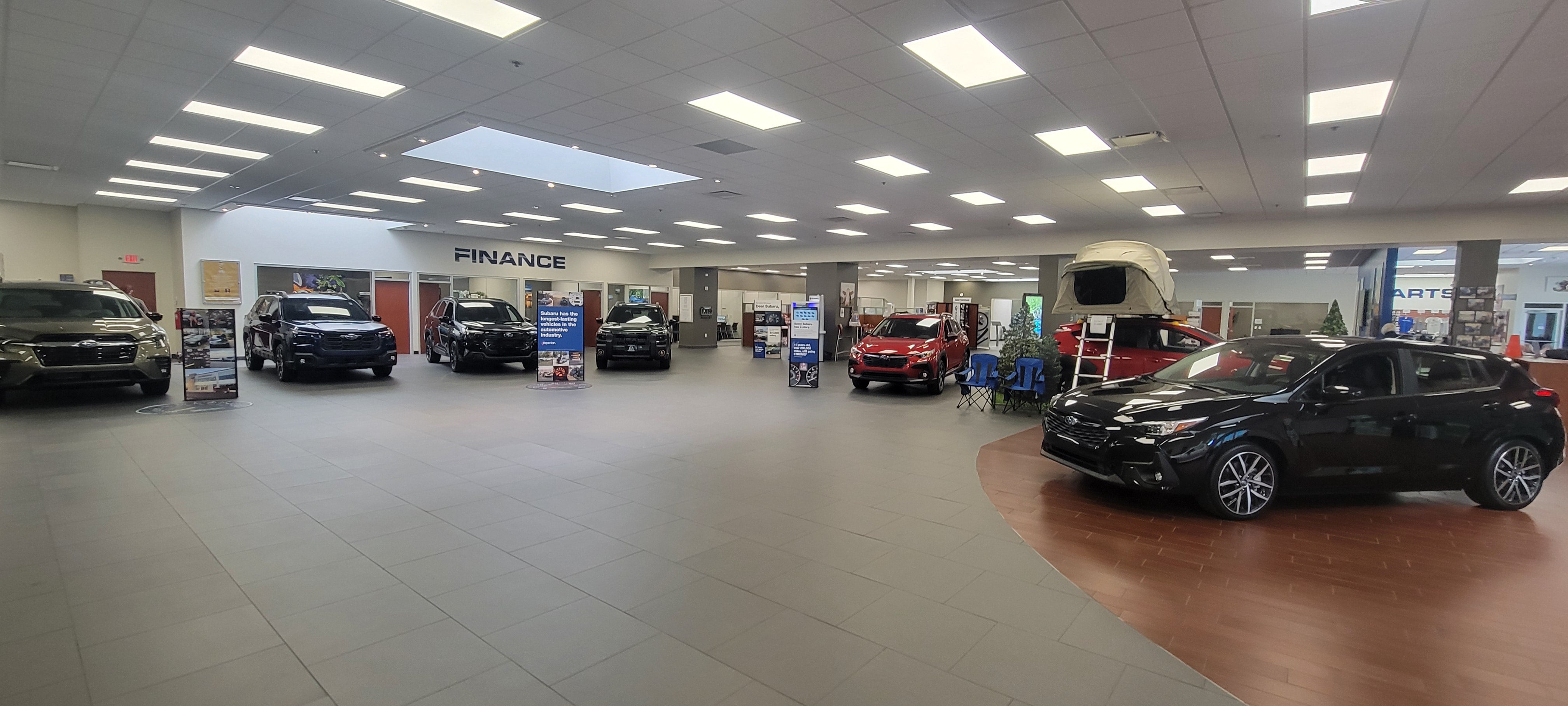 A wide-angle view of the Sunset Hills Subaru dealership showroom and finance center