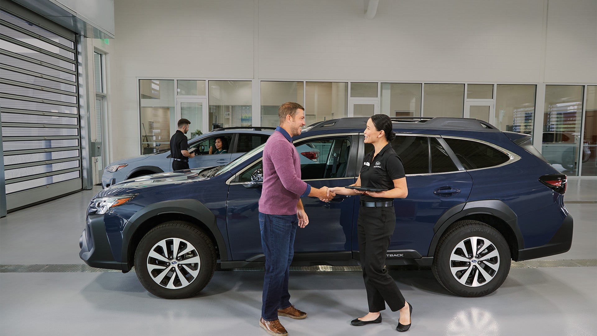 A professional appraiser inspecting a vehicle for a trade-in valuation.