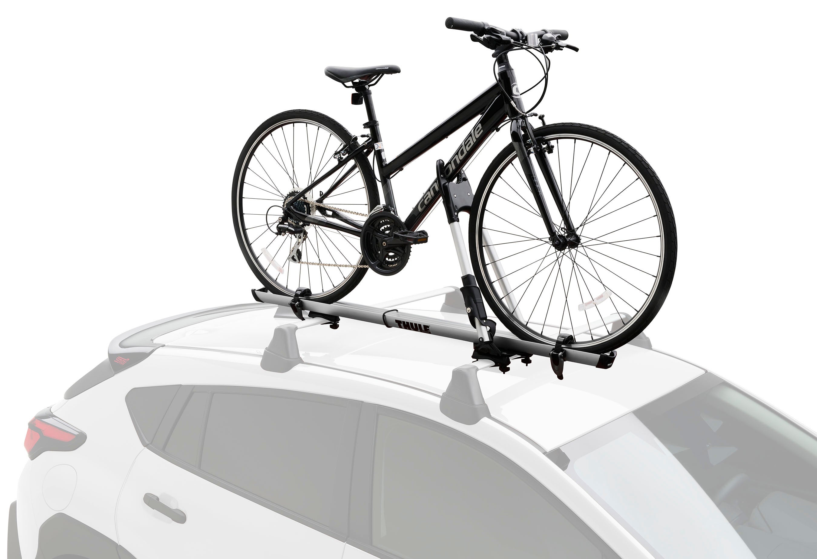 A Subaru Crosstrek equipped with Thule roof racks and a kayak carrier.