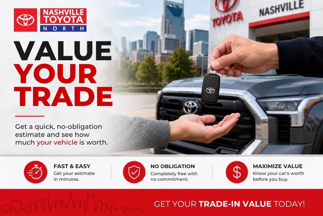 A hand is handing over car keys with a Toyota logo to another person's open hand, with a Toyota dealership and Nashville skyline in the background.