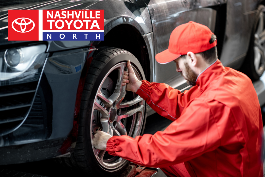 mechanic working on car tire