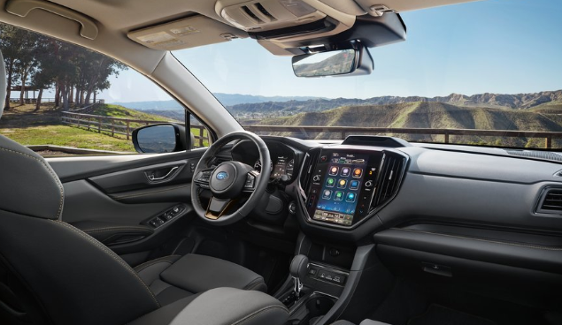 Unlimited Interior view of the Ascent Bronze Black StarTex Seat w/ Bronze stitching Instrument Panel ovelrooking the rolling hills.
