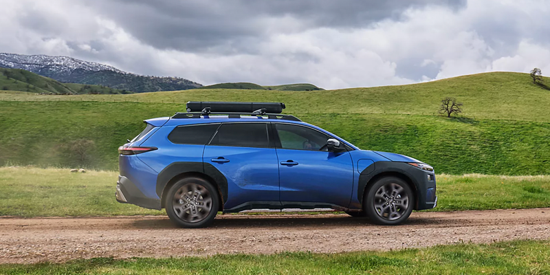 subaru vehicle on a road with greenery surrounding