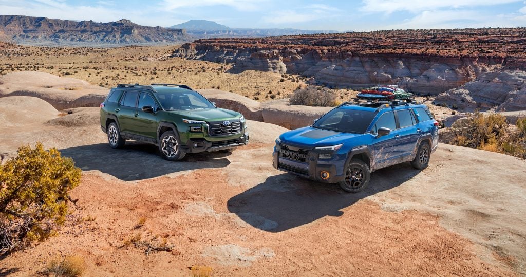 Two Subaru SUVs in desert canyon

