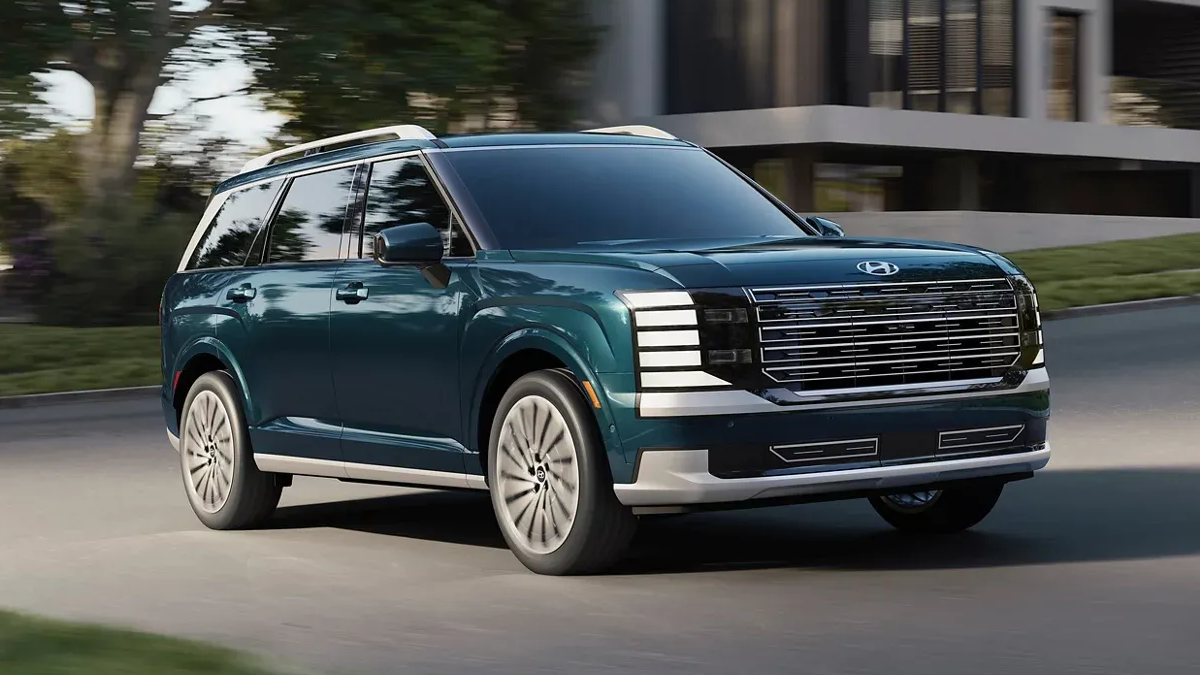 Green 2026 Hyundai Palisade driving on a city street