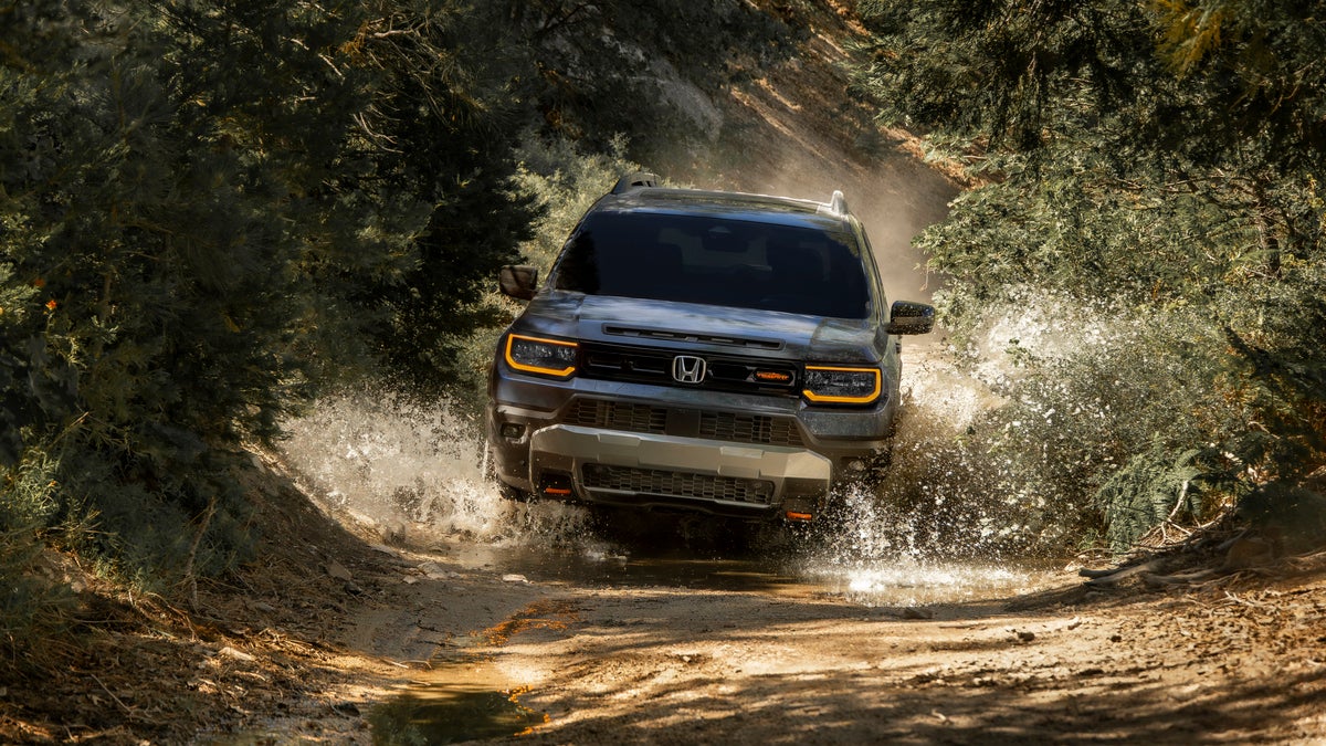 2027 Honda Passport TrailSport driving off-road through water