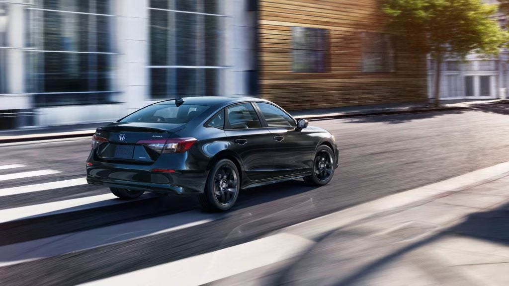 2026 Honda Civic Sedan driving in a city. 