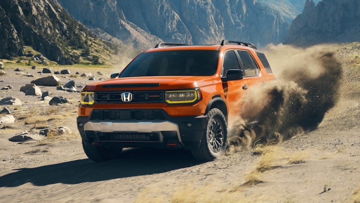 Front hero view of a 2026 Honda Passport Trailsport driving off-road.