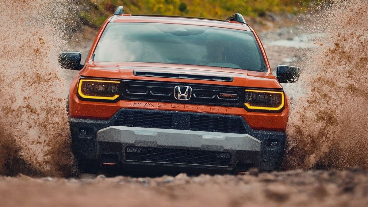 2026 Honda Passport TrailSport Elite shown in Sunset Orange.