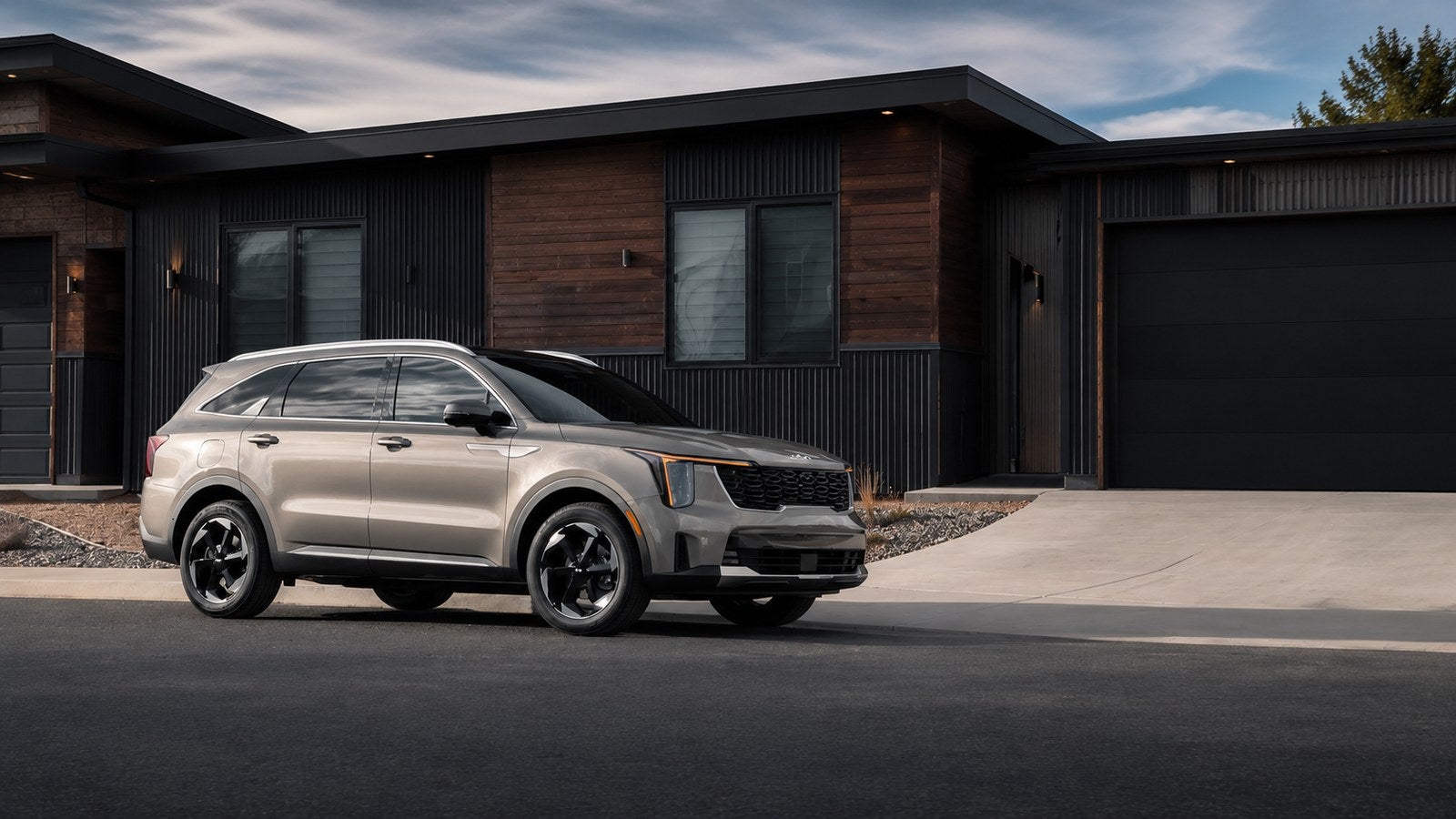 New Kia SUV parked near a home garage for spring cleaning and Kia buying tips in Waco TX