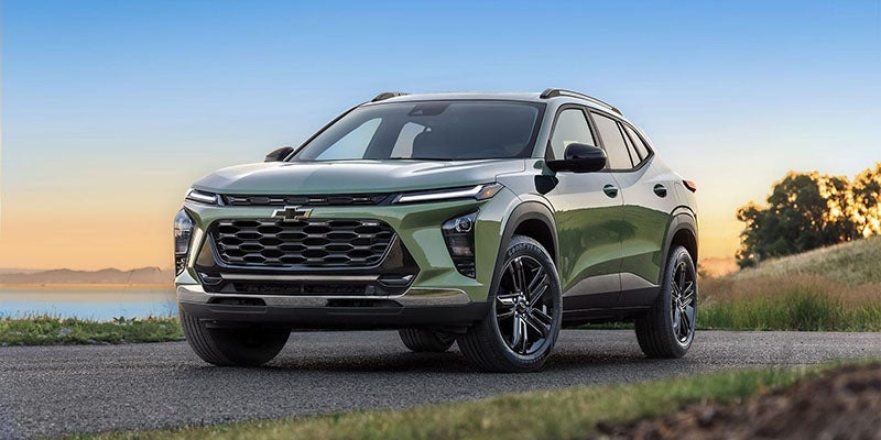 A green 2025 Chevrolet Trax parked on a beach.