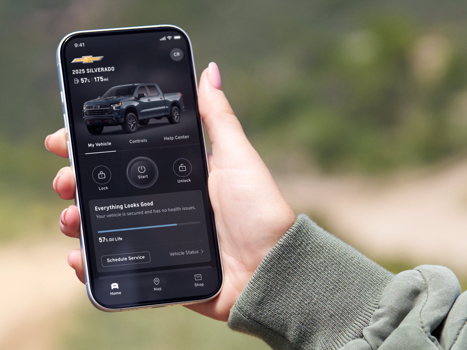 phone in hand showing connected vehicle status, remote commands and more in the app