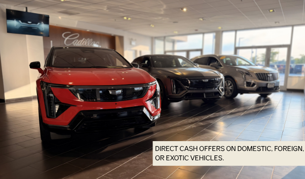 Image shows the Cadillac showroom at Arnie Bauer Cadillac. A red Cadillac Optiq is show, a Lyriq and an XT5. 