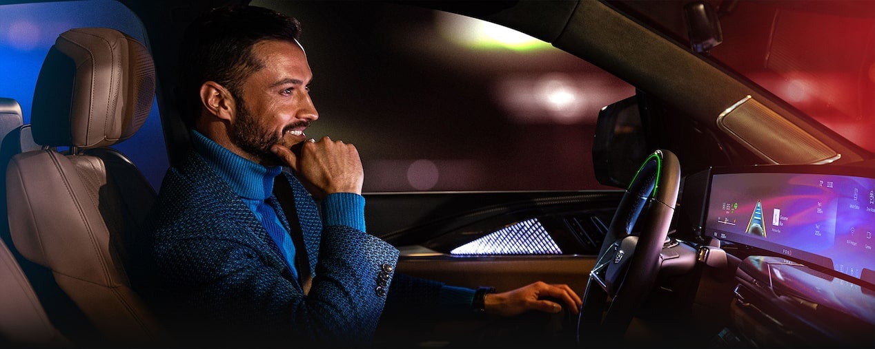Passenger View of a Woman Using Super Cruise Hands-free Driving Technology in Her Cadillac
