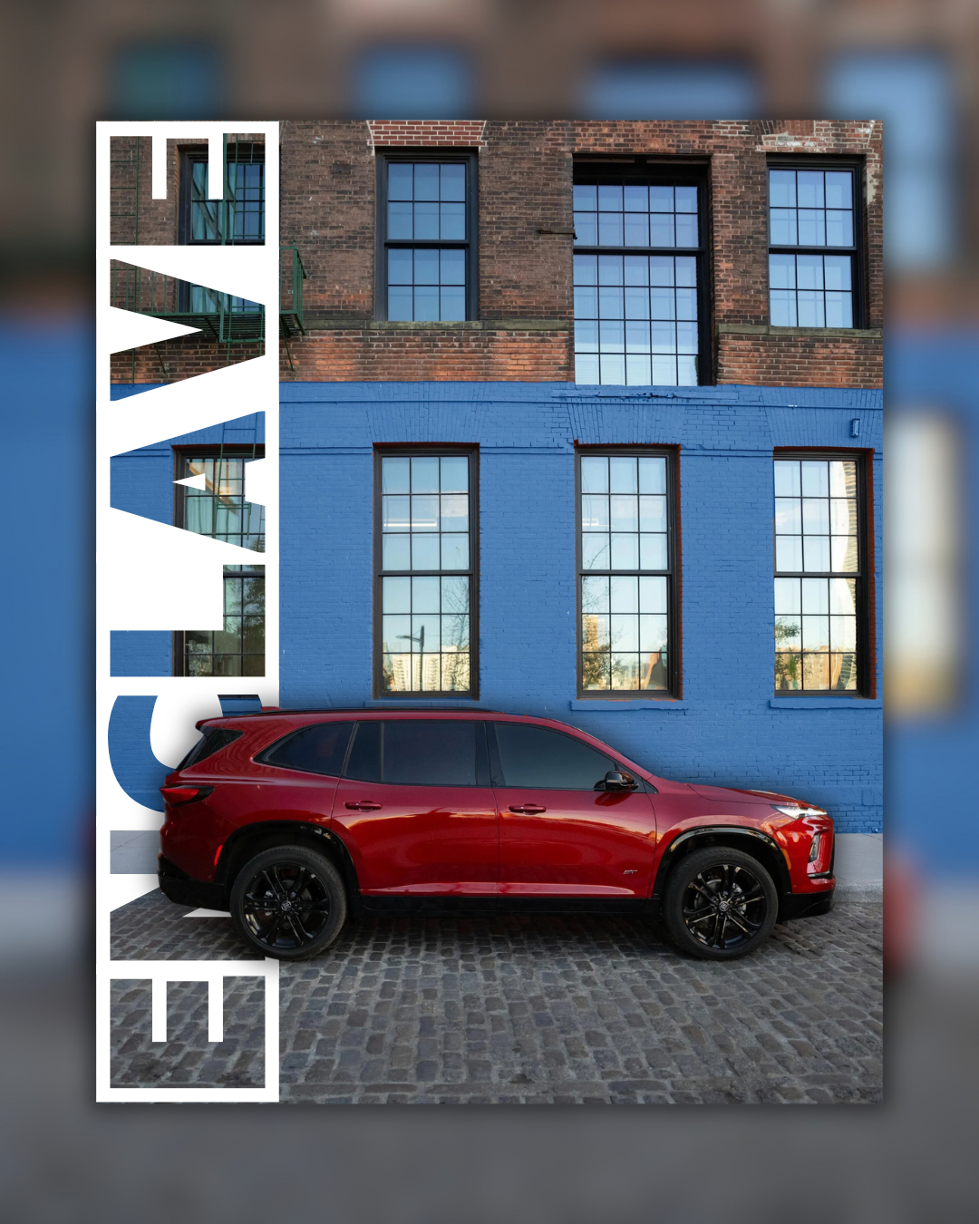 Red Buick Enclave pictured in front of a brick building