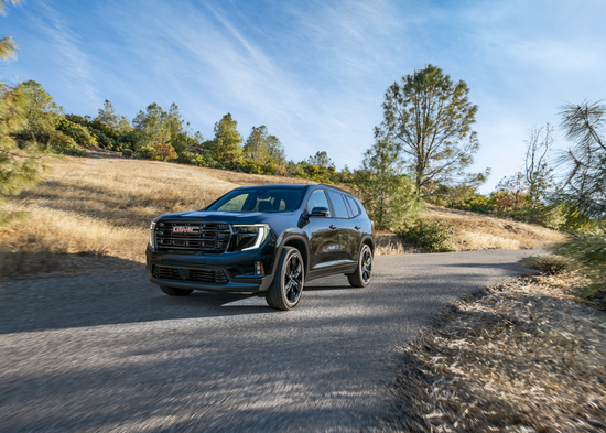 GMC Terrain that was bought online at Arnie Bauer driving down the street.