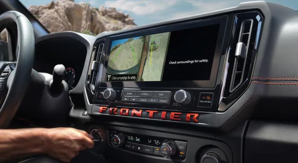 The black dash in a 2025 Nissan Frontier at a Nissan dealer in Knoxville.