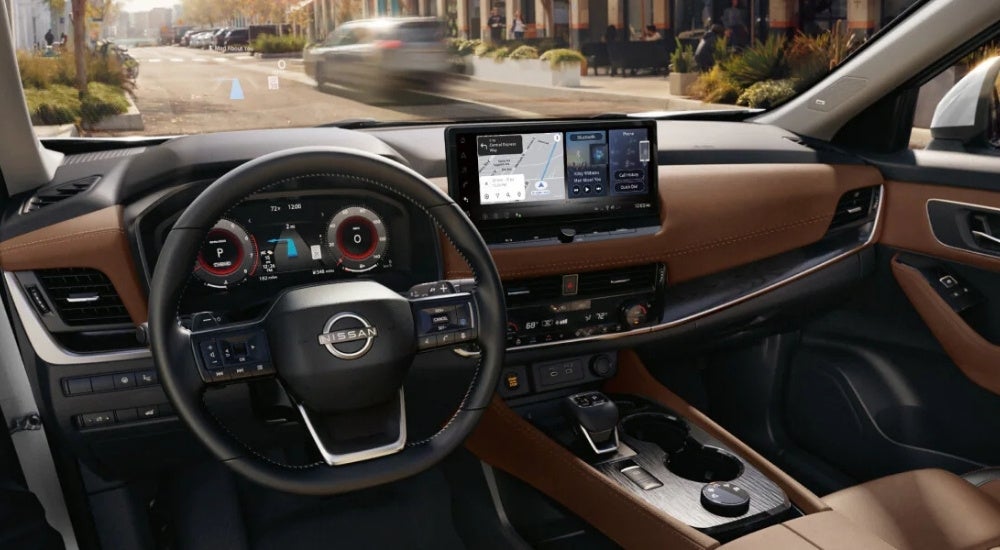 The brown interior of a 2026 Nissan Rogue from the driver's seat.