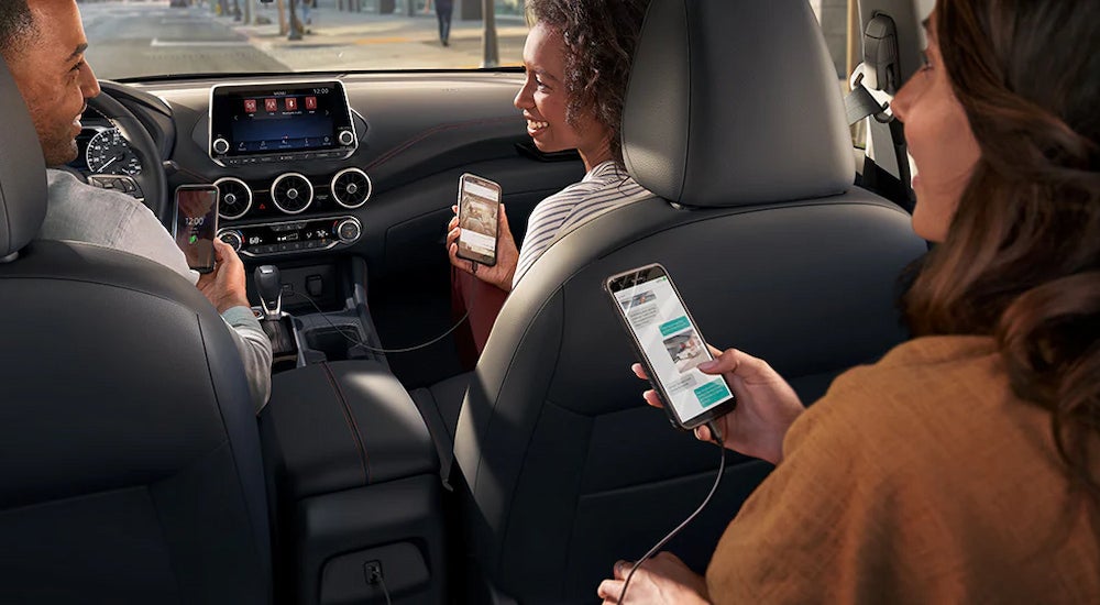 Passengers using multiple USB ports in a 2024 Nissan Sentra SR.