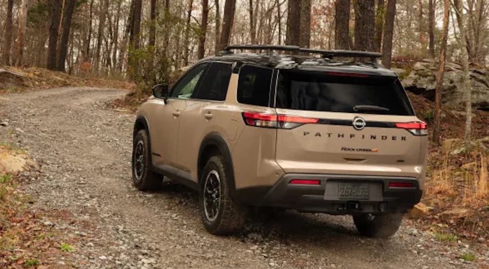 A tan 2025 Nissan Pathfinder from the rear.