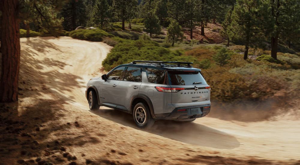 A gray 2025 Nissan Pathfinder off-roading on a trail
