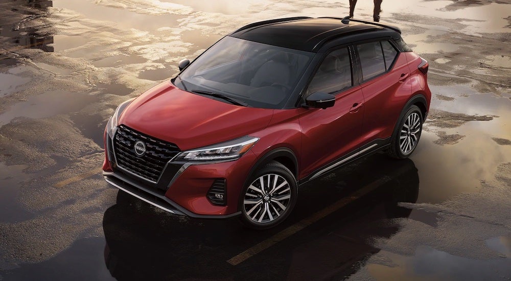 High angle view of a red 2024 Nissan Kicks for sale parked on a lot.