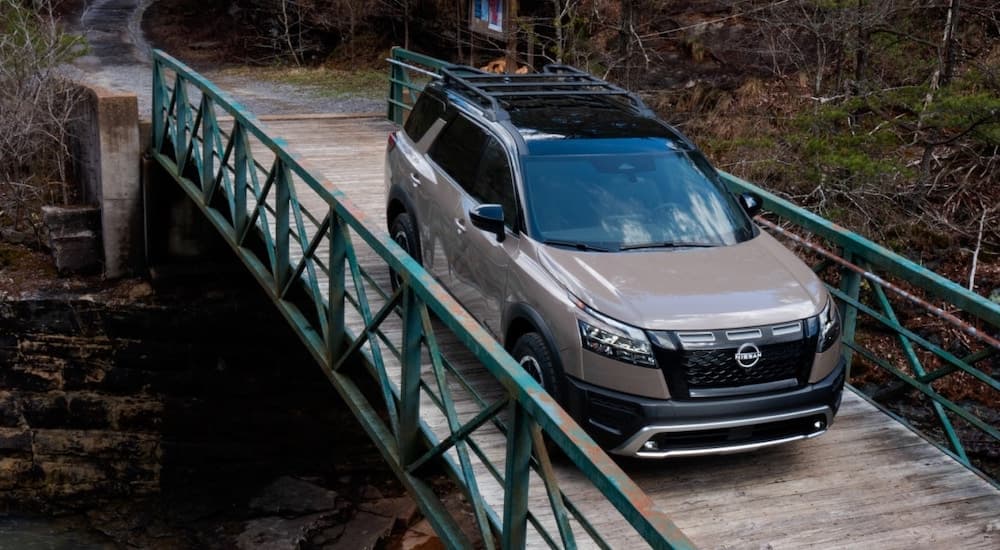 A brown 2025 Nissan Pathfinder Rock Creek is shown from the front at an angle.