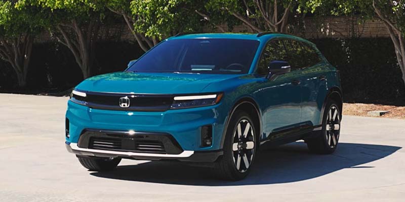 A blue 2024 Honda Prologue parked in a driveway.