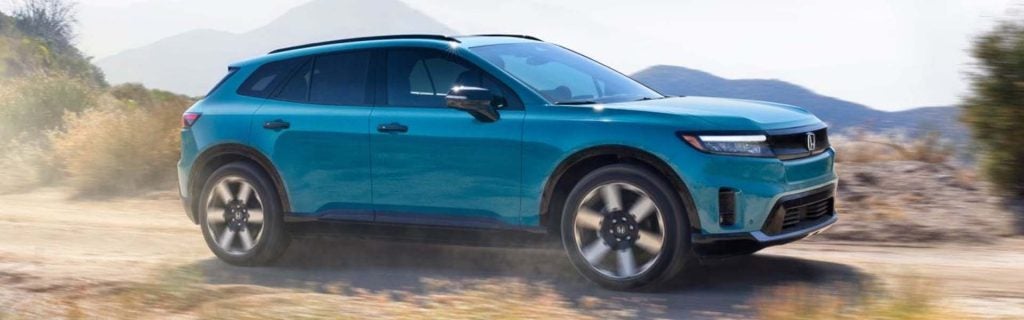2025 Honda Prologue electric SUV driving through a scenic outdoor landscape
Blue Honda Prologue showcasing modern EV design, aerodynamic styling, and all-electric capability