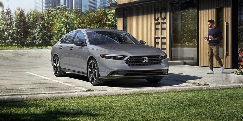 A gray 2024 Honda Accord Hybrid parked in a driveway.