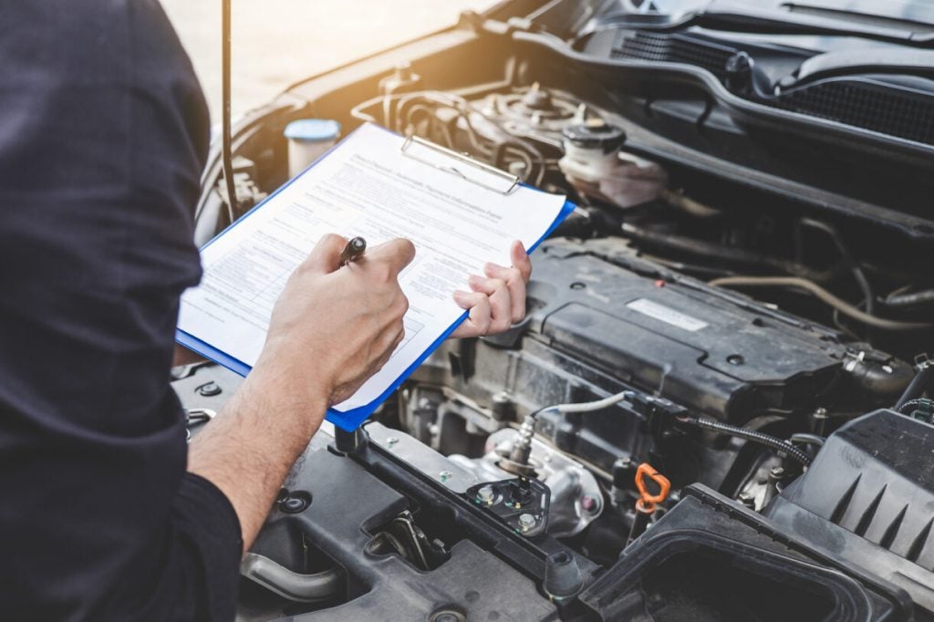 A service technician completing a vehicle inspection.