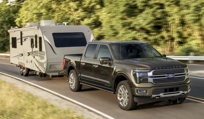 A black 2025 Ford F-150 pulling a trailer near Anderson, Indiana