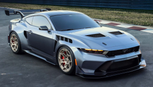 A silver 2025 Ford Mustang parked on a racetrack near Anderson, Indiana