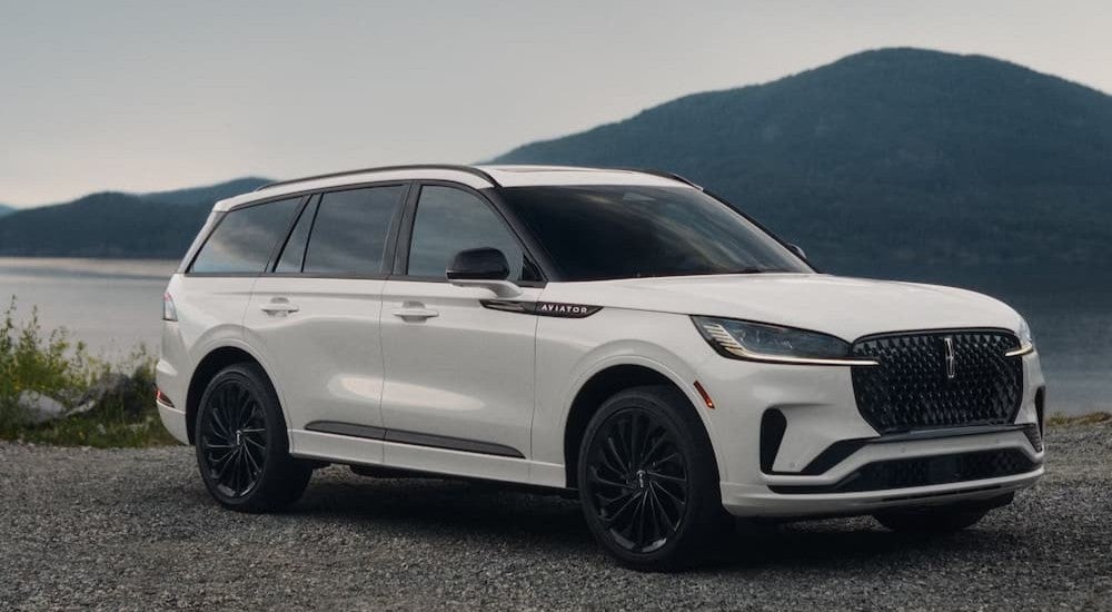 A white 2027 Lincoln Aviator parked near water.