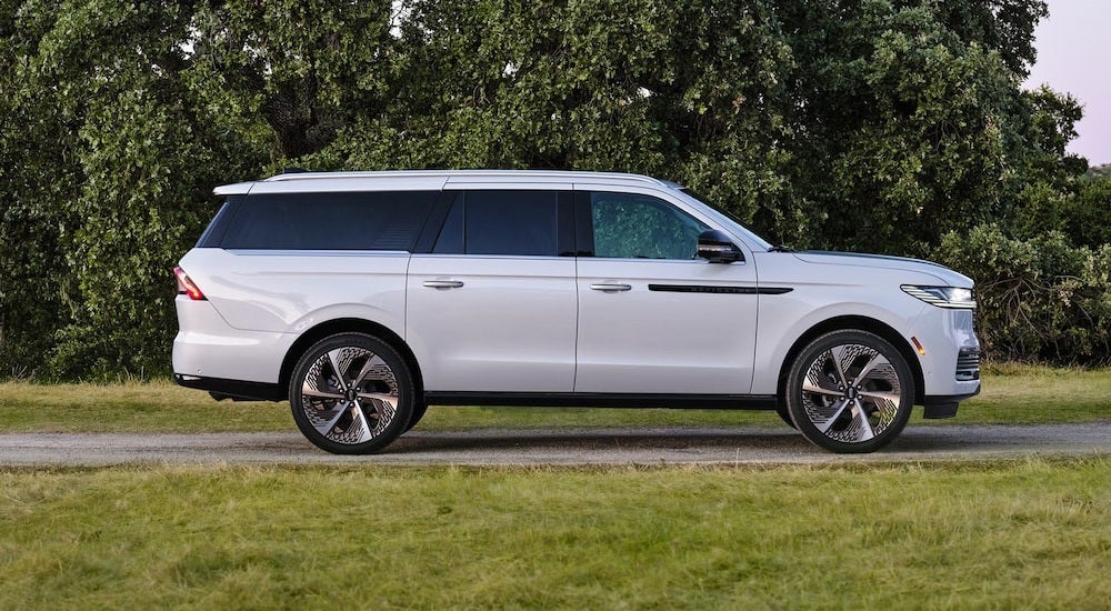 Side of a white 2026 Lincoln Navigator parked on a path.