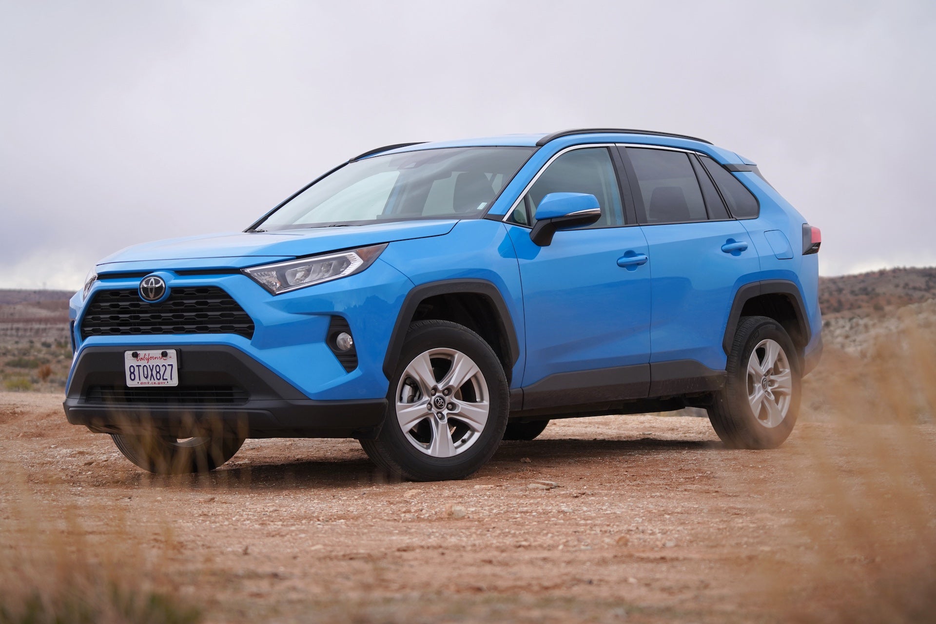 Blue Toyota RAV4 parked on a dirt road in the Utah wilderness with overcast sky. Off road driving bright blue Toyota. Photo taken near Kanab, Utah.