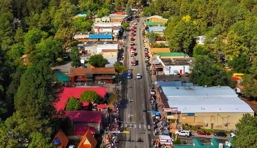 a overhead shot of a rural town area with colorful rooftops and lots of trees 