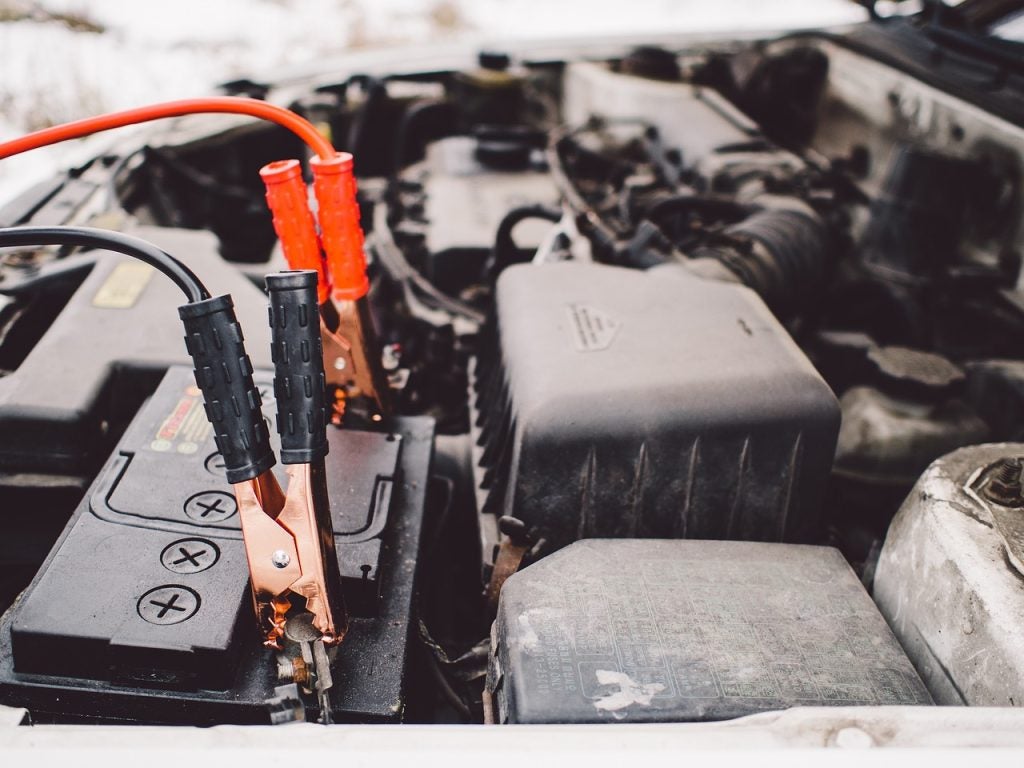Jumper cables being used to jump start a Toyota in Bishop, CA 