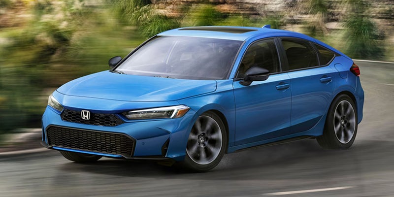 Blue Honda Civic driving on a winding road.