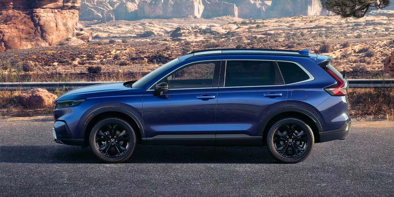A blue 2024 Honda CR-V Hybrid driving in a dessert near Bishop, CA 