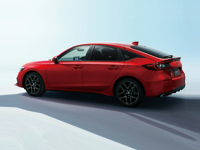 A red Honda Civic driving in a clear background