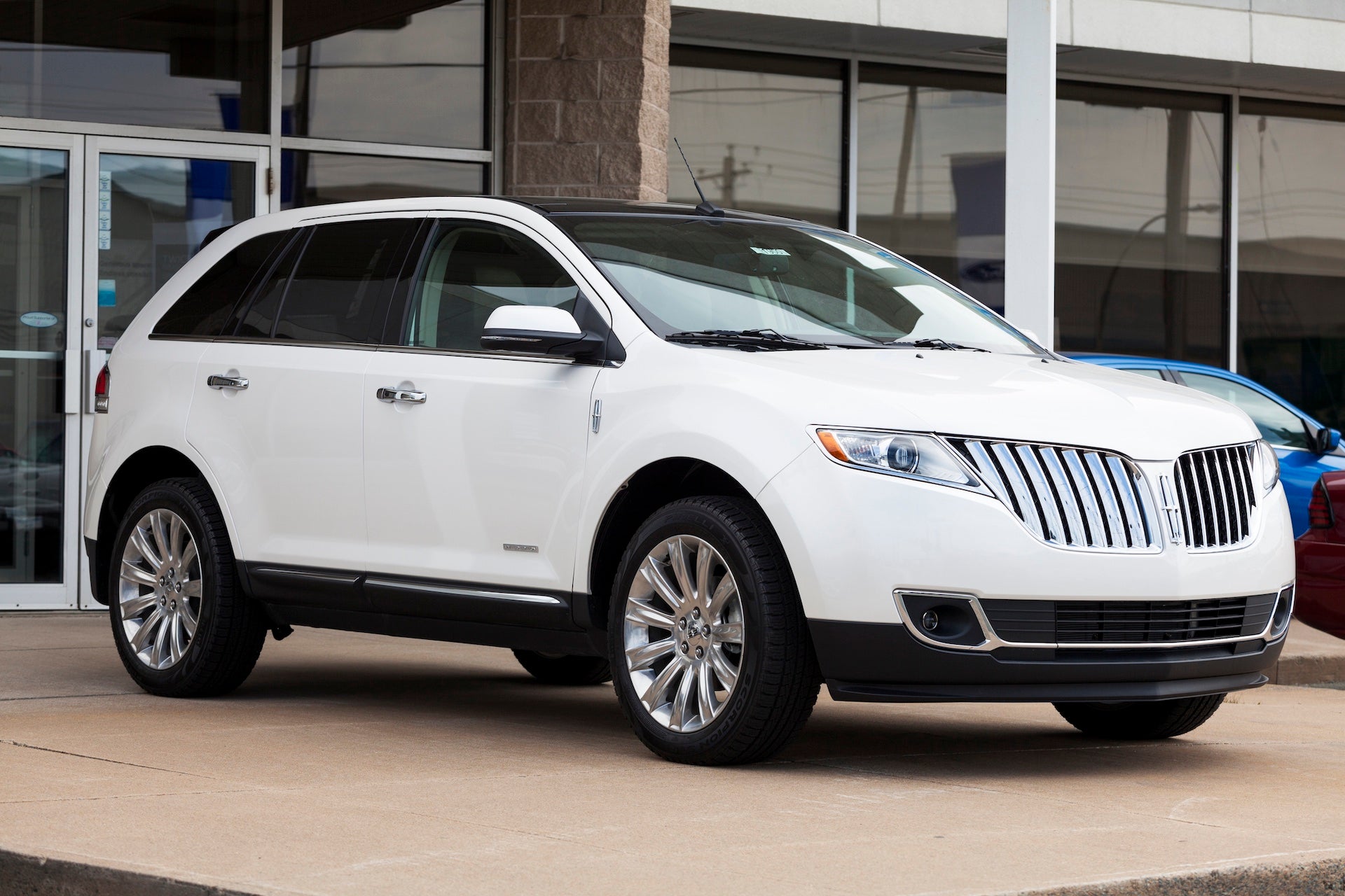 Lincoln MKX Limited Edition parked in front of a car dealership location. Showroom and entrance behind vehicle. The Limited Edition of the MKX features 20" polished aluminum wheels, "Limited Edition&amp;amp;rdquo; badging, premium leather-trimmed seats, aluminum accents on instrument panel and door-trim inserts as well as other cosmetic and comfort features.