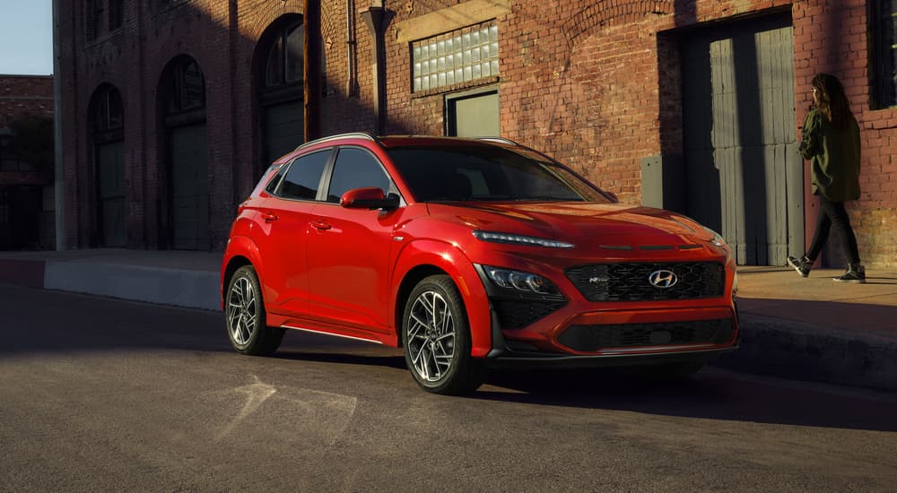 Red 2022 Hyundai Kona parked on the side of a city street