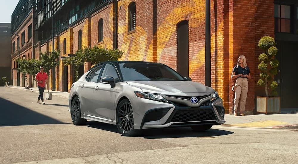 A silver 2023 Toyota Camry driving to view used cars for sale near Oak Ridge.