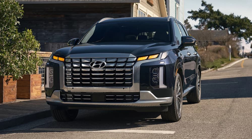 Black 2026 Hyundai Palisade stopped on a neighborhood street.