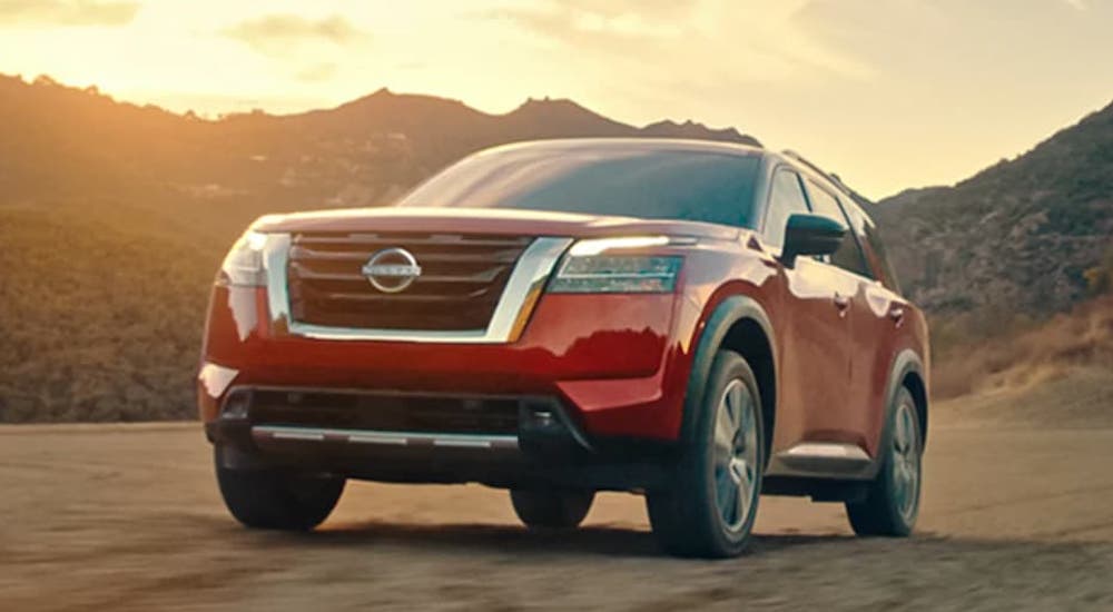 A red 2022 Nissan Pathfinder is shown from the front at an angle.