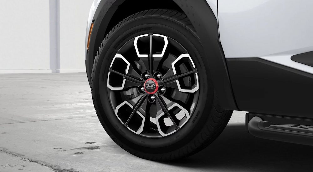Close-up of the wheel of a white 2024 Hyundai Santa Cruz XRT.