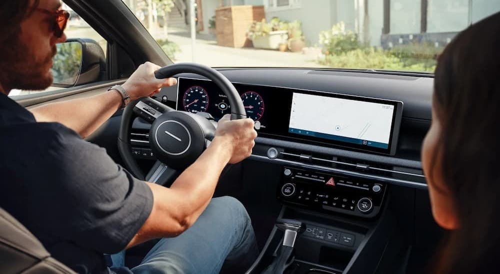 A person driving in a 2026 Hyundai Santa Cruz.