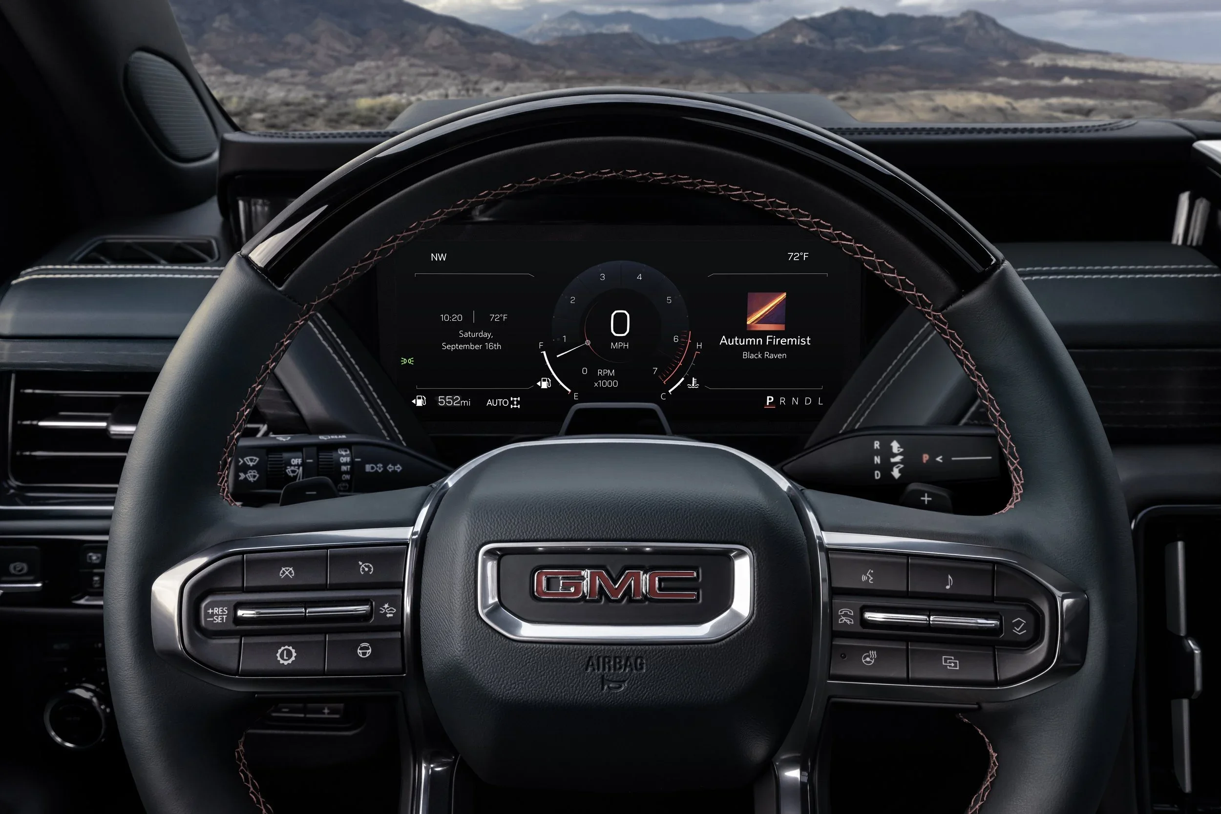 GMC steering wheel and digital driver display interior detail showing speedometer and trim colors