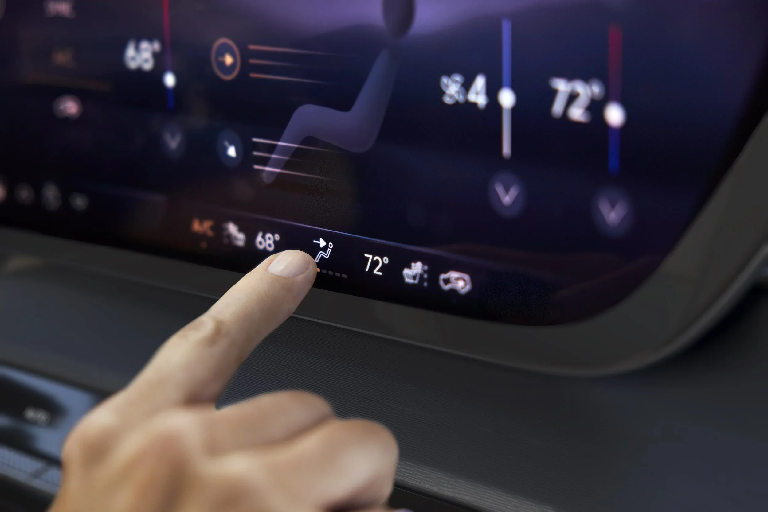 Buick interior detail of a finger touching dual-zone climate touchscreen showing heated seat icons